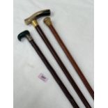A 19th Century malacca walking cane with gilded metal pommel 34" long and two other canes, one
