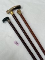 A 19th Century malacca walking cane with gilded metal pommel 34" long and two other canes, one