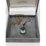 A 9ct aquamarine and split pearl pendant on necklet chain. 3.4g gross.