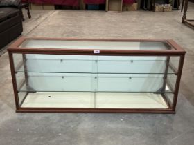 A display case enclosed by a pair of sliding glass doors. 19½" x 47½".
