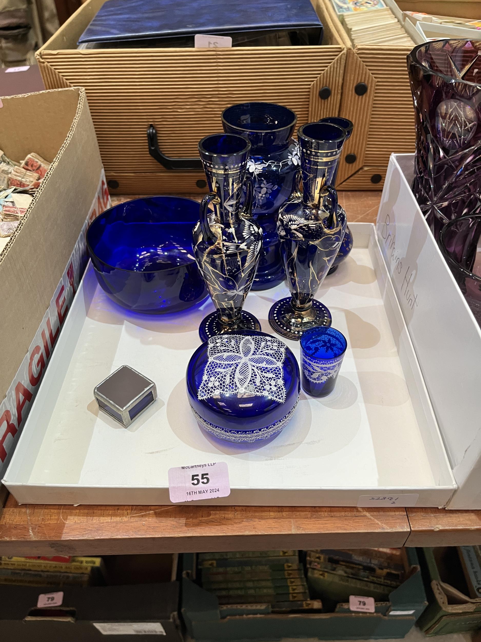 A collection of blue and amethyst coloured glassware.