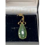 A 9ct jade pendant on necklet chain. 4.2g gross.