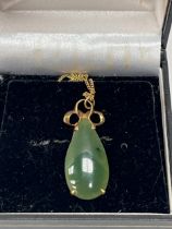 A 9ct jade pendant on necklet chain. 4.2g gross.