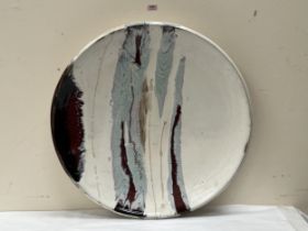 A monumental glazed studio pottery charger. Indistinctly signed and dated '93. 31" diam.
