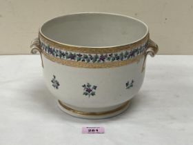 A 19th Century jardiniere, gilded and painted with a band and sprays of flowers. 7½" diam.