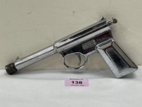 A T.J. Harrington 'The Gat' spring loaded air pistol in chrome plate.