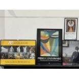 Four framed art gallery posters.