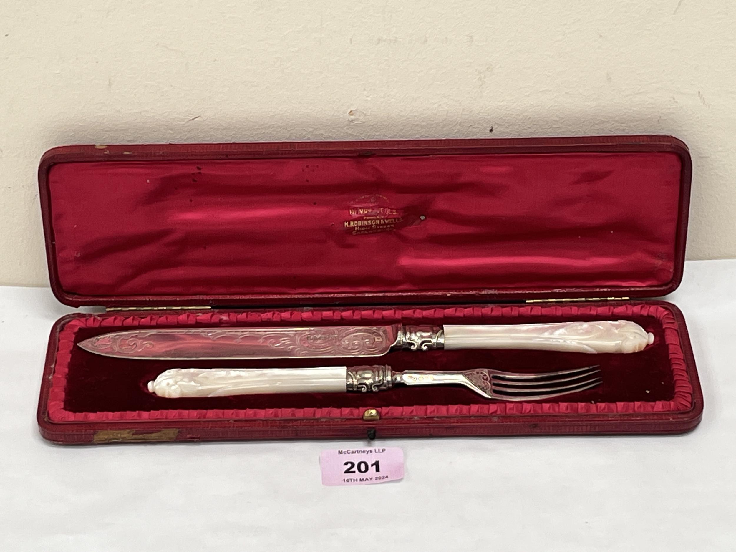 A Victorian morocco cased silver knife and fork with mother-of-pearl hafts. The knife 11" long.