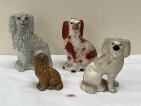 Four 19th Century Staffordshire glazed earthenware spaniels, the largest 10" high.