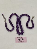 A necklace of amethyst beads with silver clasp. 20" long.