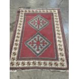 A red ground rug. 59" x 40".