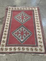 A red ground rug. 59" x 40".