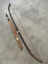 A treen longbow, 63" long, with eight spear tip arrows.