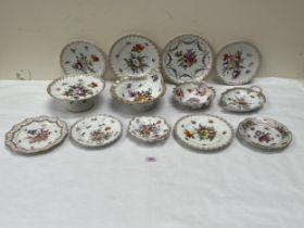 A part dessert service and other Dresden ceramics, all decorated with sprays of summer flowers.