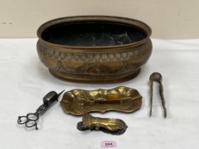 A 19th Century brass oval jardiniere, 14" wide; other brassware and a Georgian steel candle