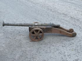 A bronze cannon on wood carriage. Length of barrel 46".