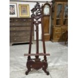 A carved wood easel of recent manufacture. 67" high.