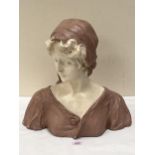 A French plaster bust of a lady after H. Laurens. Signed to the reverse. 16" high.