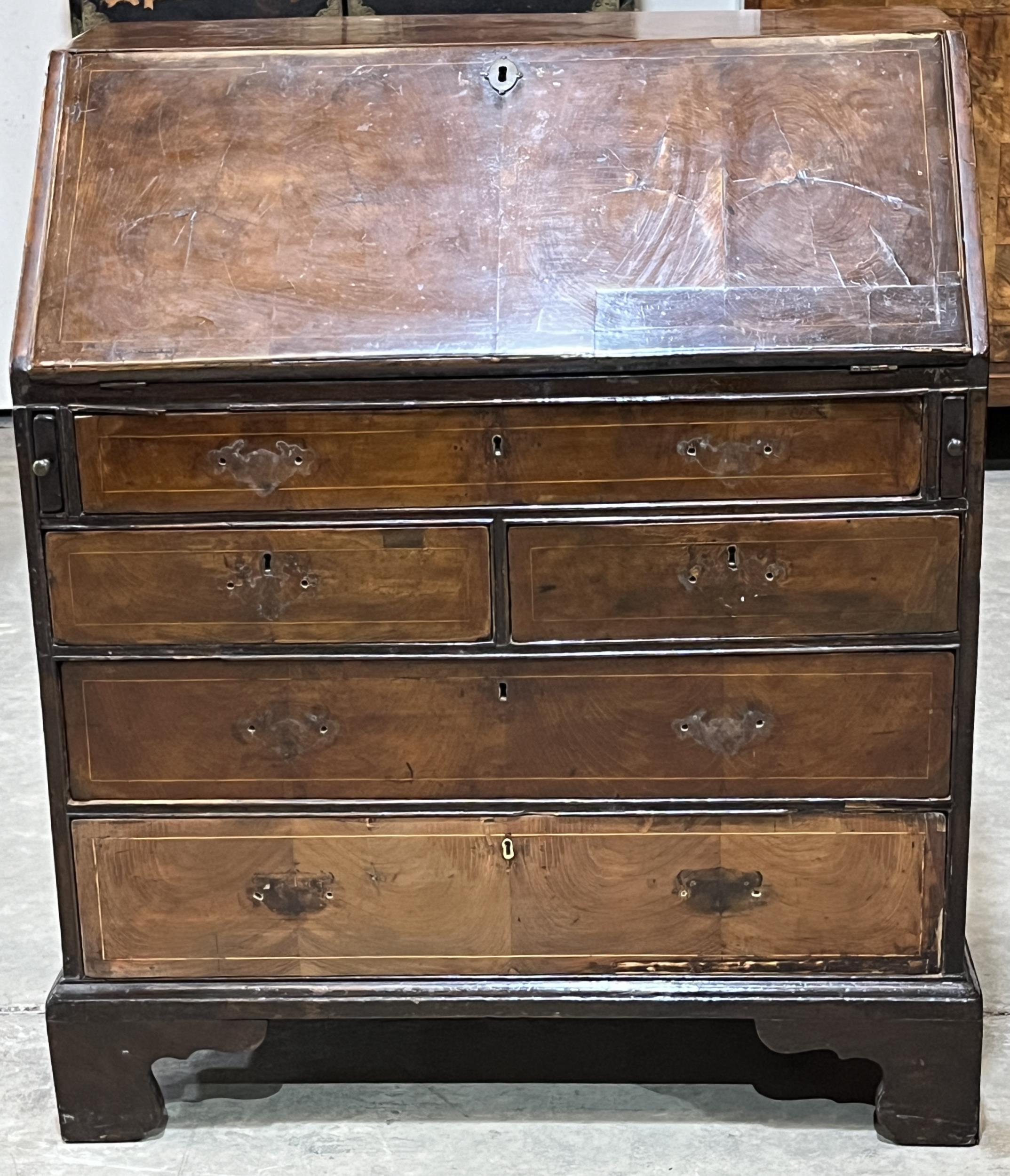 A George III yew wood bureau with fitted interior, raised on bracket feet. 33" wide.