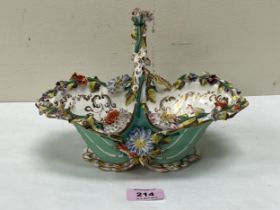 A 19th Century Coalport porcelain basket, encrusted with a profusion of coloured flowers on a