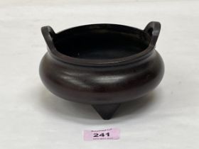 A Chinese bronze censer of circular bombe form, with two handles on three feet. Six figure character