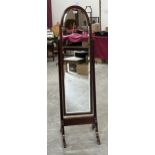 An Edward VII mahogany cheval dressing glass with break-arch bevelled plate. 60" high.