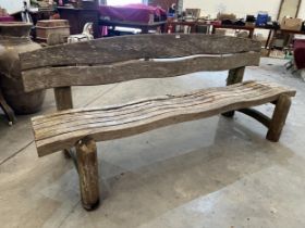 An unusual teak garden bench of organic form. 86" wide.