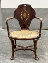 An Edward VII mahogany and inlaid open armchair in the manner of Cornelius Smith, with shaped curved
