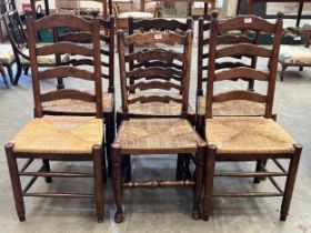 A set of four and a pair of ladder back chairs with rush seats.
