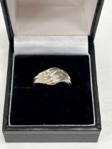 An 18ct white gold diamond ring. 3.5g gross. Size N.
