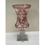 A ruby overlaid cut glass flower vase. 13¾" high.