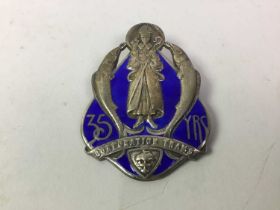 GROUP OF FOUR SILVER BADGES,