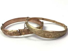 TWO NINE CARAT GOLD BANGLES,