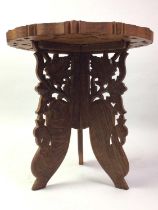 FOUR INDIAN HARDWOOD CARVED CIRCULAR TABLES, AND A CAKE STAND