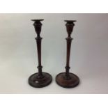 PAIR OF TURNED MAHOGANY CANDLESTICKS, AND A GLASS FISHING FLOAT