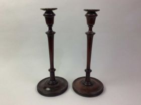 PAIR OF TURNED MAHOGANY CANDLESTICKS, AND A GLASS FISHING FLOAT