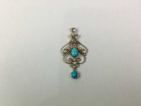 NINE CARAT GOLD AND TURQUOISE HOLBIEN PENDANT,