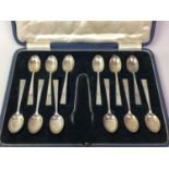 SET OF TWELVE SILVER TEASPOONS AND TONGS IN A FITTED CASE,