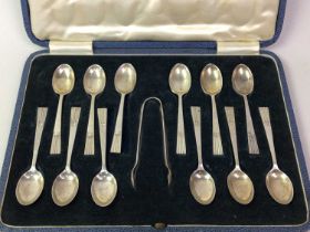 SET OF TWELVE SILVER TEASPOONS AND TONGS IN A FITTED CASE,