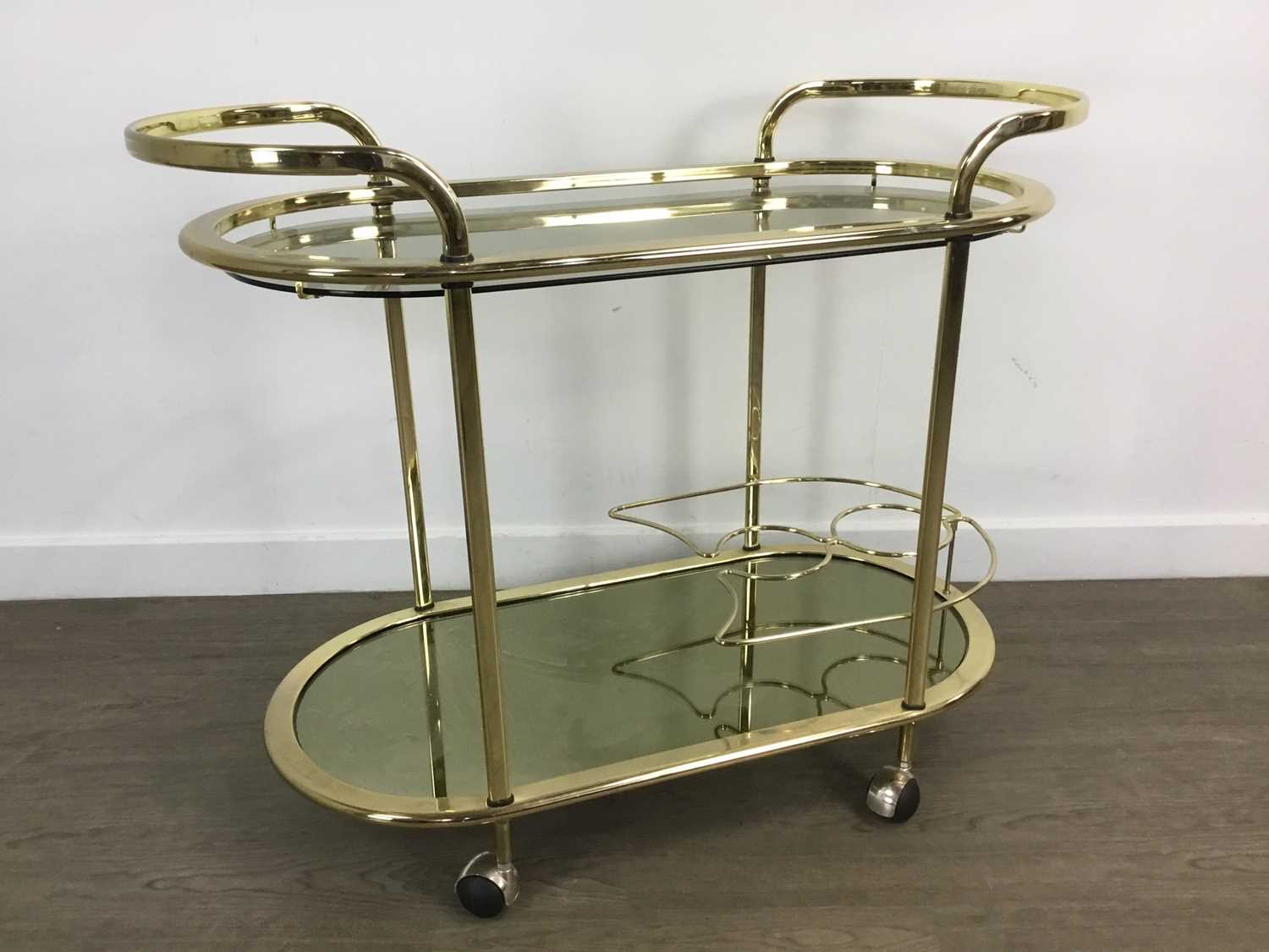 ATTRIBUTED TO MILO BAUGHMAN, GILT METAL AND GLASS DRINKS TROLLEY, CIRCA 1970-79