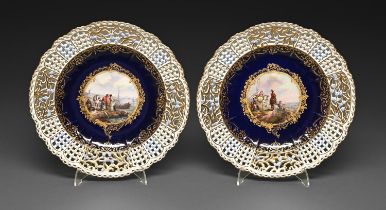 A pair of Meissen plates, late 19th c, painted to the centre with figures on the shore or a cavalier