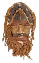 Tribal art. West Africa - a carved and painted wood mask, Dan, Ivory Coast, mid 20th c, decorated