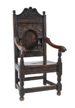 An oak panel back armchair, 17th c and later, 117cm h Wear to back legs causing the chair to lean