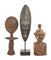 Tribal art. Three various African wood carvings, including a doll, 39cm h