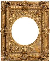 A giltwood and composition picture frame, c1870, with high relief applied masks and Venus shells,