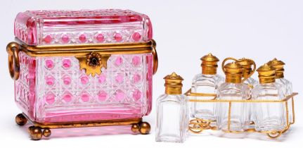 A French gilt lacquered brass mounted pink flashed and cut glass scent casket and set of six