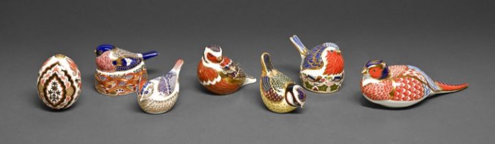Seven Royal Crown Derby paperweights, including an egg, printed mark and gilt stopper or stopper