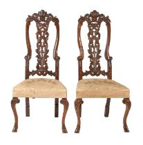 A pair of Anglo-Dutch walnut side chairs, early 18th c, shaped serpentine backs pierced and carved