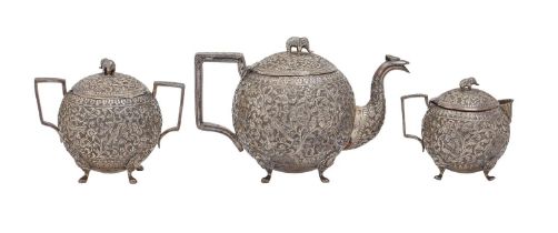 An Indian silver spherical repousse tea service, Cutch, late 19th c, with elephant finial, teapot