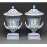 A pair of Wedgwood blue jasper ware campana vases and covers, 20th c, sprigged with An Offering to